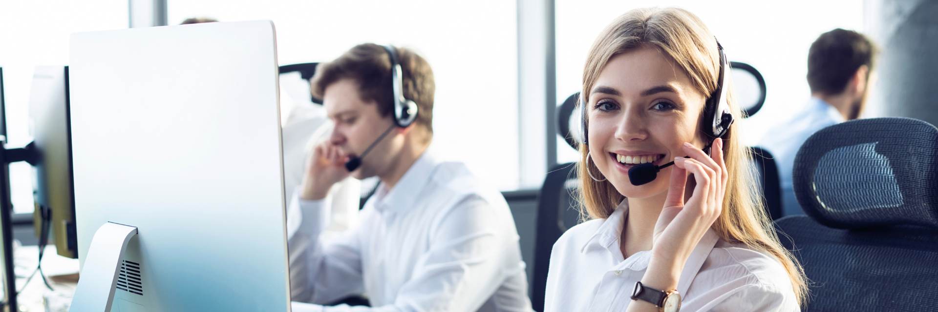 woman smiling on a call using a headset