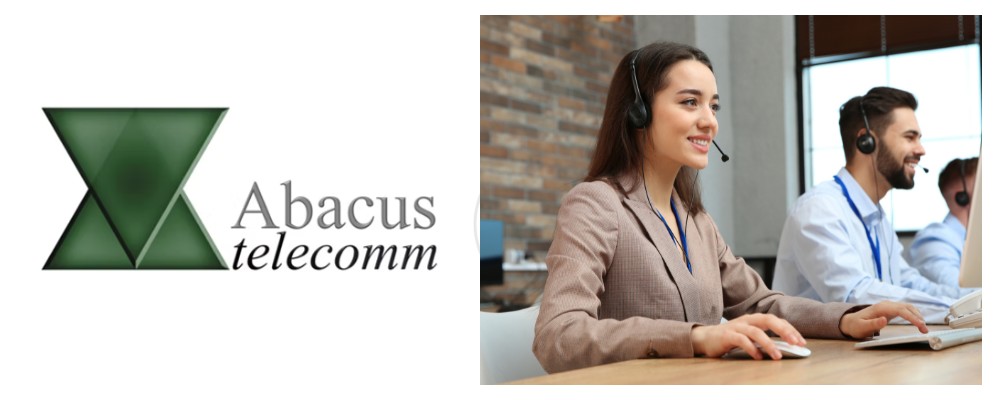 An Abacus Telecomm agent in a light brown suit using a headset linked to a SIP telephone