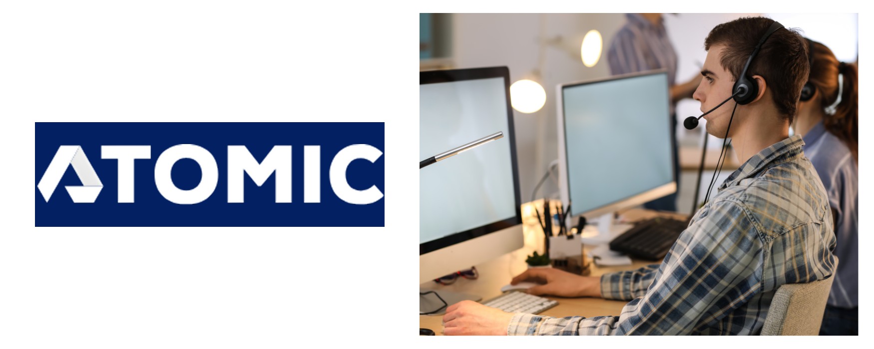 A call centre agent using his headset and working on his desktop computer using business fibre