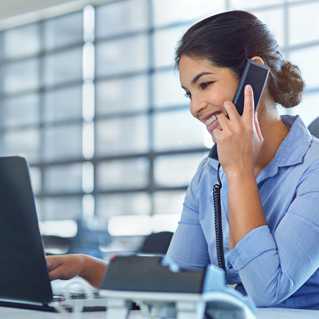 Customer service agent on a call while working at her laptop.