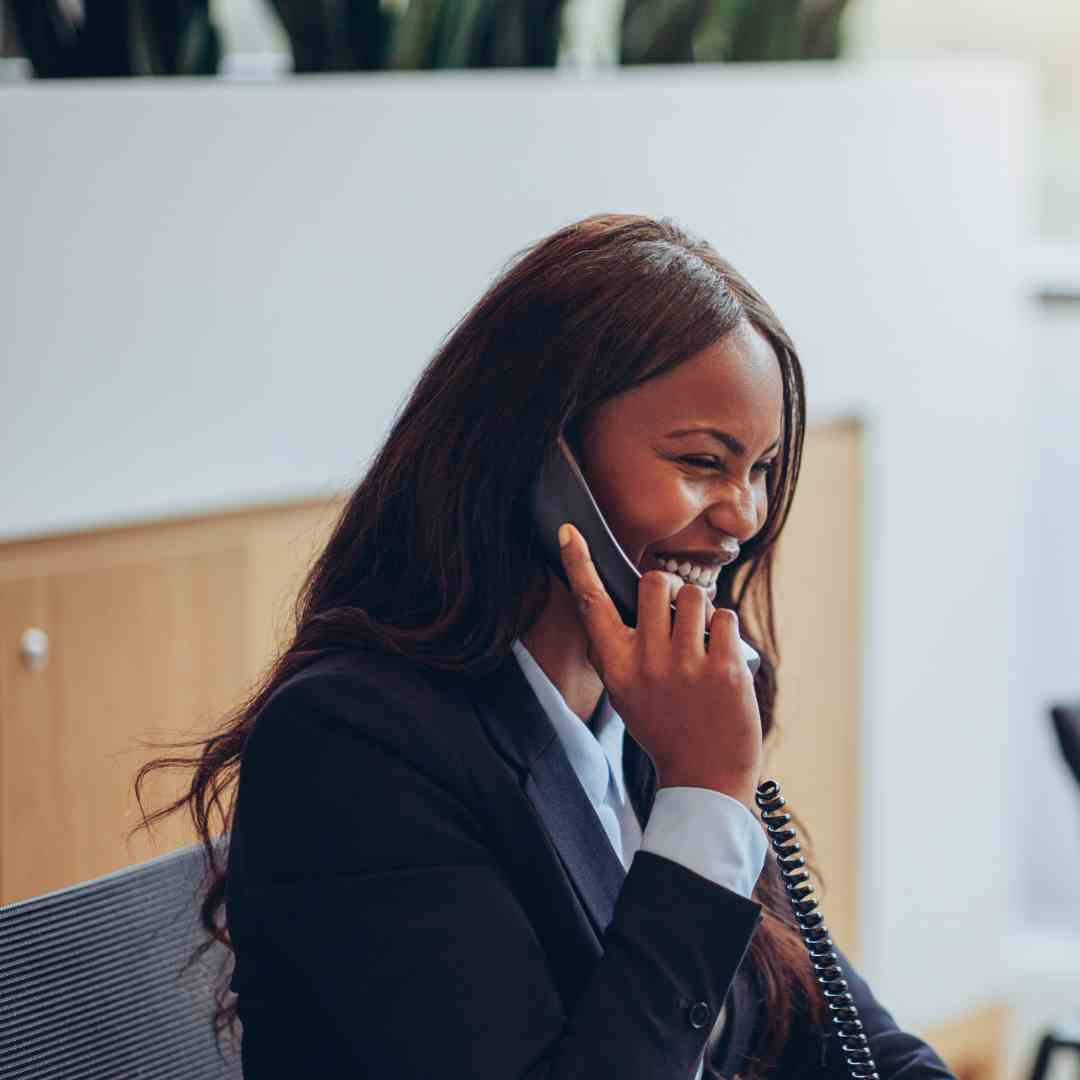 Woman education administrator speaking with a client using a Fanvil phone