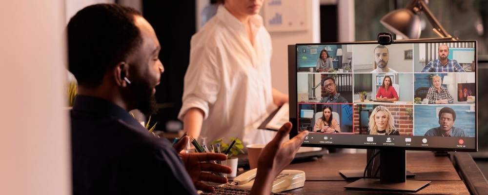 Black business owner using VoIP and Microsoft Teams on his computer to have a meeting with his clients