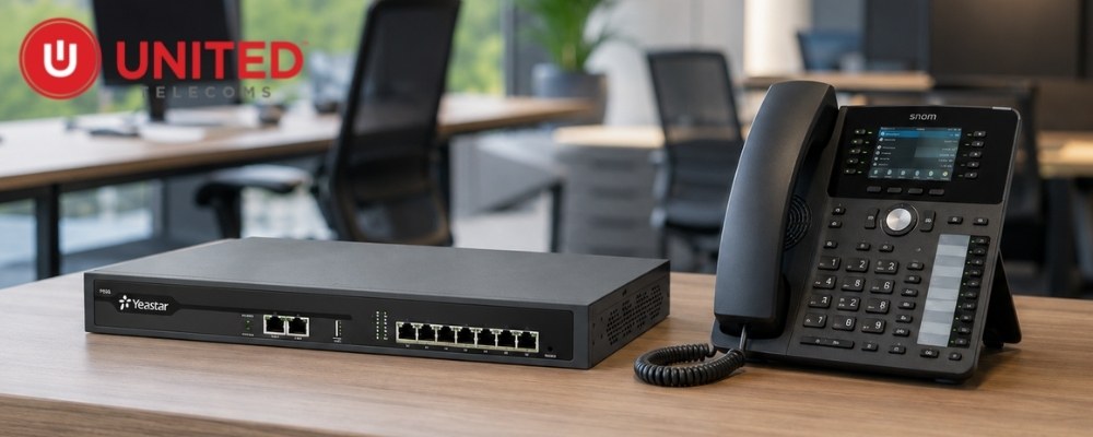 Yeastar P550 PBX unit next to a Snom VoIP desk phone, all on top of a table.