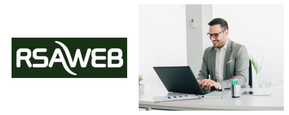 A business owner wearing a smart grey suit, working on his laptop using RSA Web business fibre