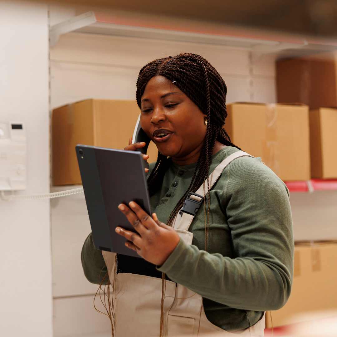 A retail worker, using a Snom phone to contact a supplier