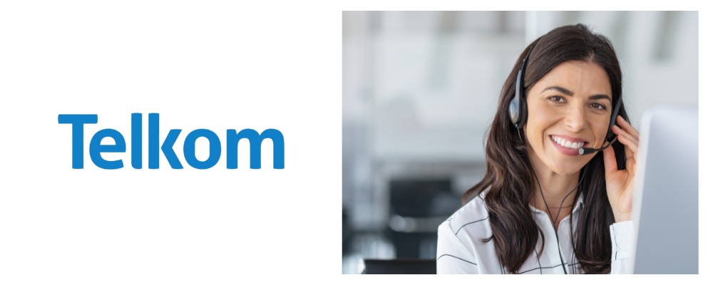 A Telkom agent smiling and wearing a white top and headset discussing business fibre with a client in Durban