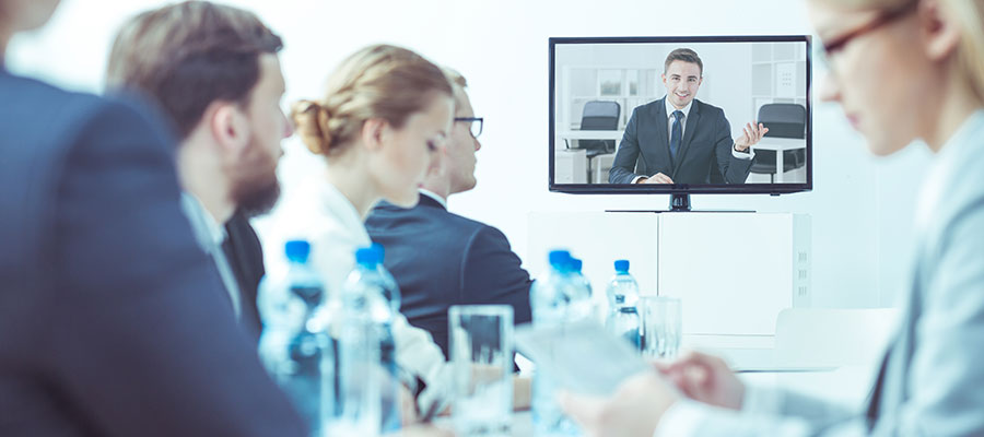 video conferencing between colleagues in meeting room