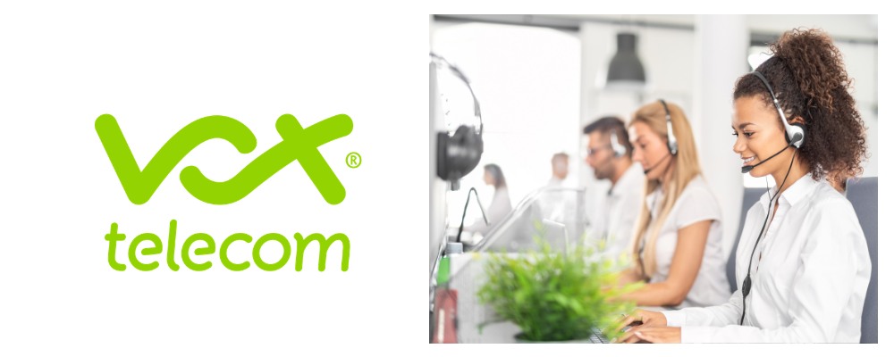 Vox consultant wearing a white top and using a headset while smiling