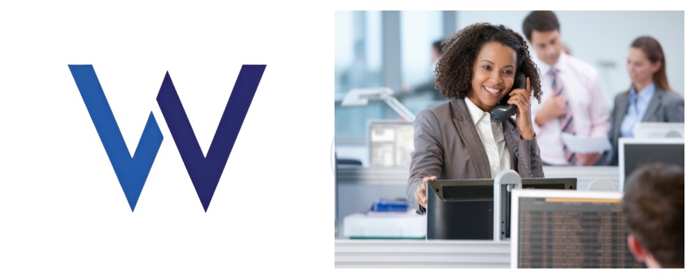 A Wanatel consultant in a smart grey suit using a SIP telephone