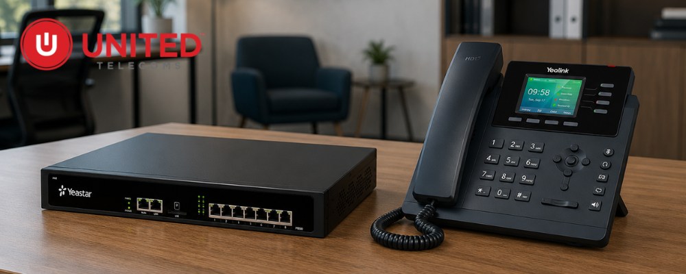 A Yeastar s50 pbx unit and a Yealink VoIP deskphone on a table.